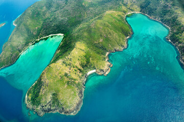 Aerial view of part of the Whitsunday Island at Great Barrier Reef. The blue waters are deeper than...
