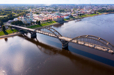 Fototapeta premium Drone view of the small Russian city of Rybinsk with the longest and original bridge over the Volga River on a summer day