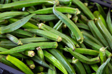Obraz premium Fresh green okra on the counter market. Organic vegetable, Asian food ingredients