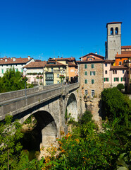 Scenic view of ancient arched bridge Ponte del Diavolo across Natisone river in small Italian town of Cividale del Friuli - obrazy, fototapety, plakaty