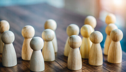 Group of diverse wooden figurines in a line, symbolizing unity, teamwork, and community in social gatherings, isolated on a wooden table background with Christmas decorations