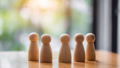 Group of diverse wooden figurines in a line, symbolizing unity, teamwork, and community in social gatherings, isolated on a wooden table background with Christmas decorations