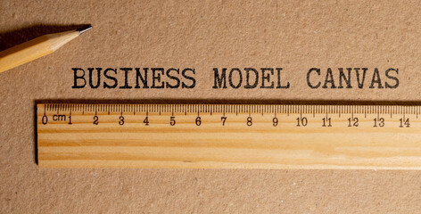 Business Model Canvas. Paper ship and sheet on a gray background - obrazy, fototapety, plakaty