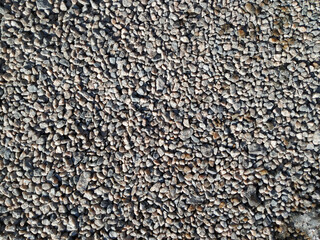 Gravel in the form of small gray stones close-up. Top view, copy space.