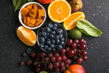 Assortment of fresh exotic fruits and berries on concrete table, flat lay