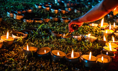 Close up burning candles during Loi Kratong festival in Chiangmai temple