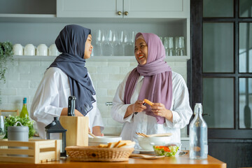 Cute Girl And Her Muslim Mom In Hijab Preparing Pastry For Cookies In Kitchen, Baking Together At Home. Islamic Lady With Daughter Enjoying Doing Homemade Pastry