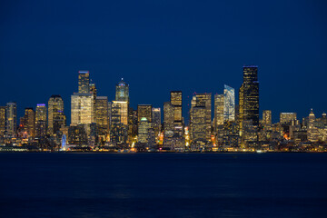 Seattle central business district across Elliott Bay during blue hour illuminated