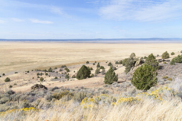 View across Goose Lake in Northern California in fall with arid landscape