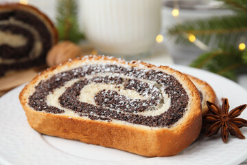 Slice of poppy seed roll and anise star on plate, closeup. Tasty cake