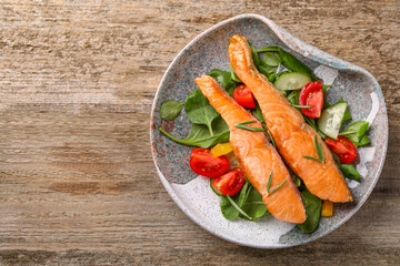 Healthy meal. Tasty grilled salmon with vegetables and spinach on wooden table, top view. Space for text