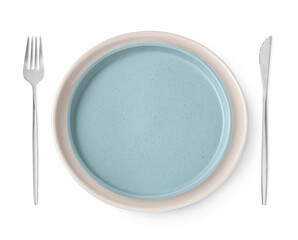 Clean plates, fork and knife on white background, top view