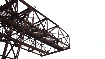 Building structure of rusty steel in construction, white sky