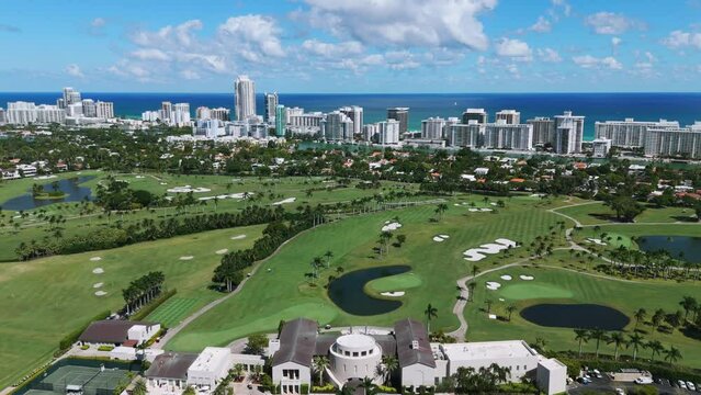 Areal view of wonderful fashionable resort next to multi-storey district with waterfront on background. Spectacular private territory of golf course in La Gorce Club