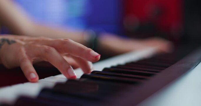 Abstract female hand playing keyboard instrument. Dj or music producer making audio tracks.