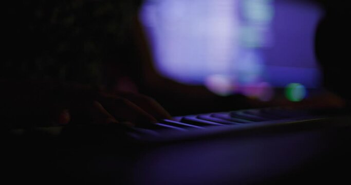 Abstract Female Hands Playing Keyboard Instrument. Girl DJ Or Producer Making Music. Colorful Flashing Lights. View From Above.