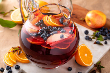 Winter orange and berry sangria with sliced oranges and blueberries