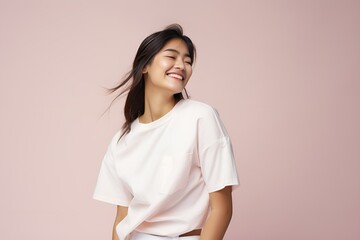 Obraz premium Portrait of a joyful fictional Asian woman smiling. Graceful and elegant lady. Natural beauty. Happiness. Isolated on a plain colored pastel background. Generative AI.
