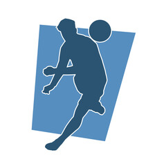 Silhouette of a muscular man playing ball. Silhouette of a male with an athletic body in action playing a ball.