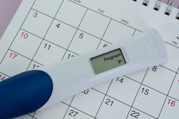 Positive pregnancy test on calendar.