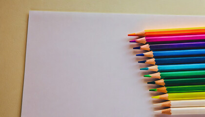 Obraz premium White paper and colorful colored pencils, top view