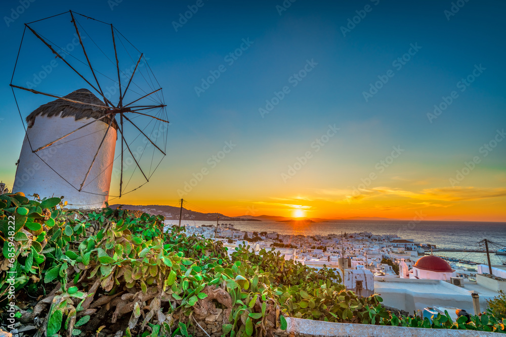 Poster windmill at sunset in mykonos, greece