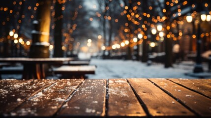 Wooden table covered with snow Empty space with an illuminated Christmas town square. Generative AI.