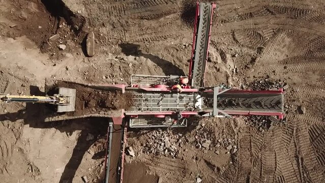 the machine sorts the soil with the participation of people