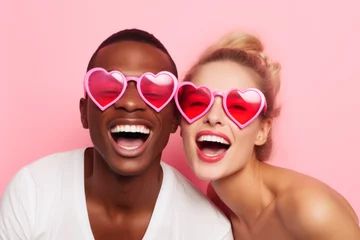 Fotobehang Happy Multiracial couple in pink heart shaped glasses in love. St. Valentine's day concept. © sderbane