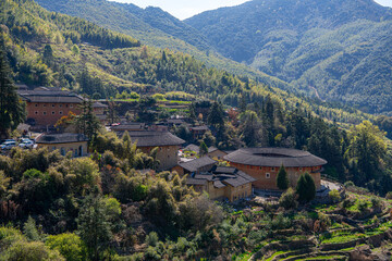 Two hundred years old Tulou in Fujian, China surrounded by the mountains