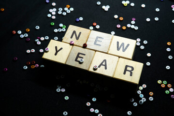 New year resolutions with writing block with a collection of letters in the background