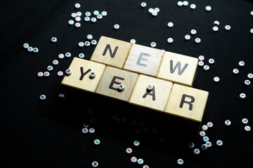 New year resolutions with writing block with a collection of letters in the background