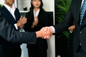 Asian business people shake hand after made successful agreement deal in meeting room, professional hand shaking with applause in corporate company. Quaint
