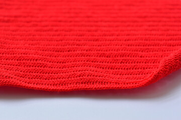 red wool knitted yarn texture, woolen fabric on white background