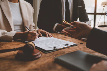A lawyer, investor, businessman, entrepreneur is reviewing a business contract or insurance contract for future benefits or a businessman signs a document and receives a loan to start a new business.