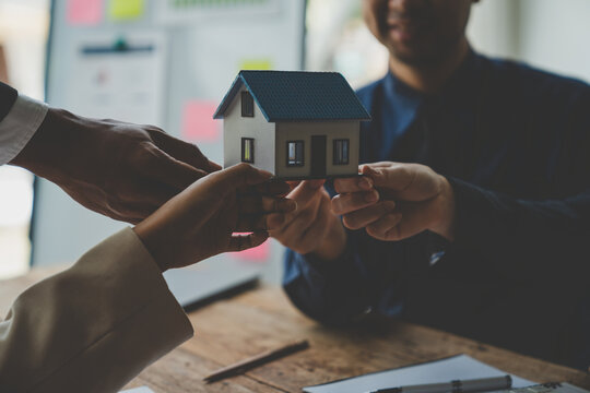 Real estate agents, investors and insurance salespeople give sample homes to clients after signing a sales contract at the office.