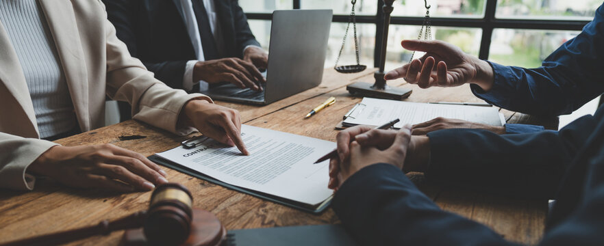 A lawyer, investor, businessman, entrepreneur is reviewing a business contract or insurance contract for future benefits or a businessman signs a document and receives a loan to start a new business.