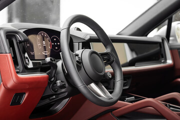 car Interior - steering wheel, shift lever and dashboard, climate control, speedometer, display  in luxury car.