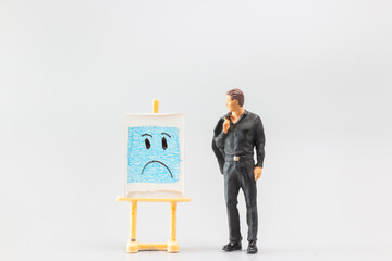 Miniature people, A dejected businessman is positioned in front of a white board, Blue monday...
