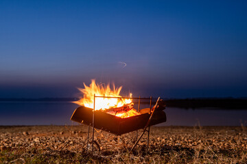 Bonfire by the lake in the evening