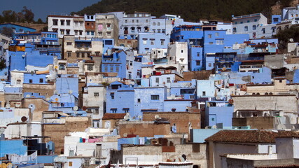 Blue and white buildings on a hill in the medina, in Chefchaouen, Morocco