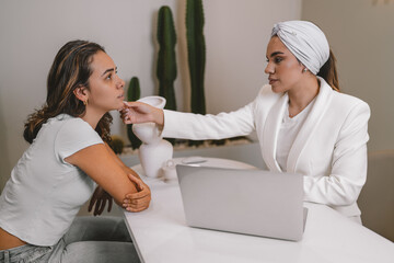 Esthetician doctor evaluating the facial intervention of a patient