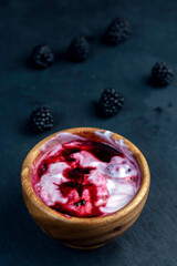 fresh yogurt with crushed juicy blackberries, preparation of yogurt