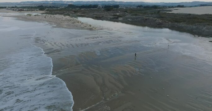Aerial Drone shot of Solitary Man Running on Pismo Beach California at Sunrise