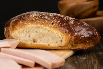 slicing a finished piece of ham into small pieces