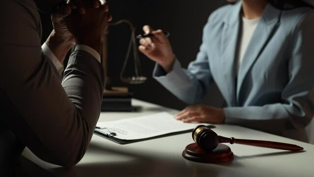 Lawyer, legal , Asian businesswoman explaining agreement details Business contracts to investors and brainstorming Take notes for accuracy in the document before signing the contract together.	