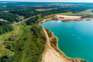 Aerial view of a flooded sand quarry with blue water