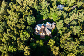 Landscape from above with a view of an old mansion among a green forest. Turliki Estate, Russia