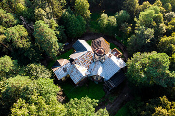 Landscape from above with a view of an old mansion among a green forest. Turliki Estate, Russia