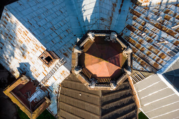 Aerial view of the roof of an old manor house with a turret and spire